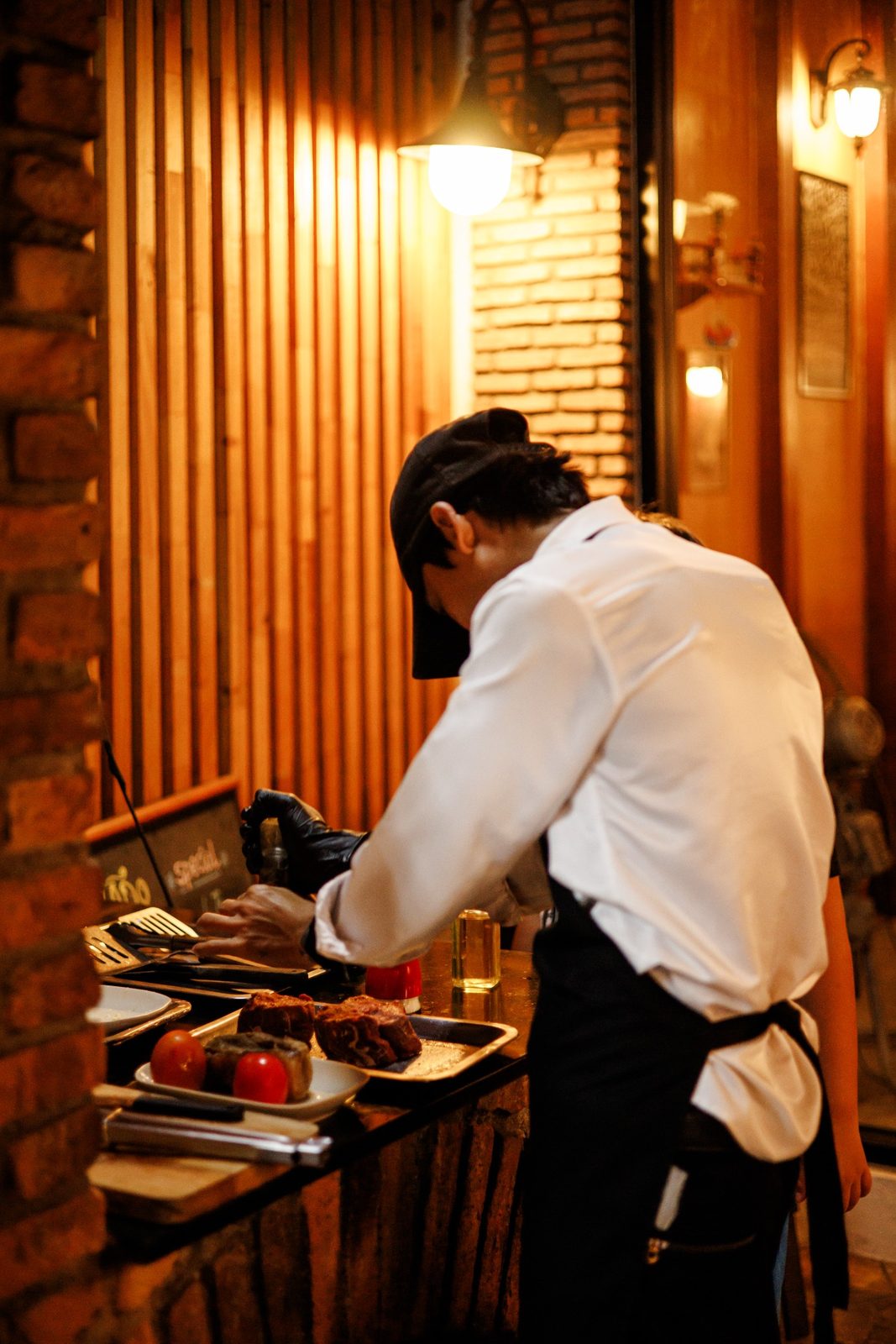 ASADO chef working at the parrilla grill