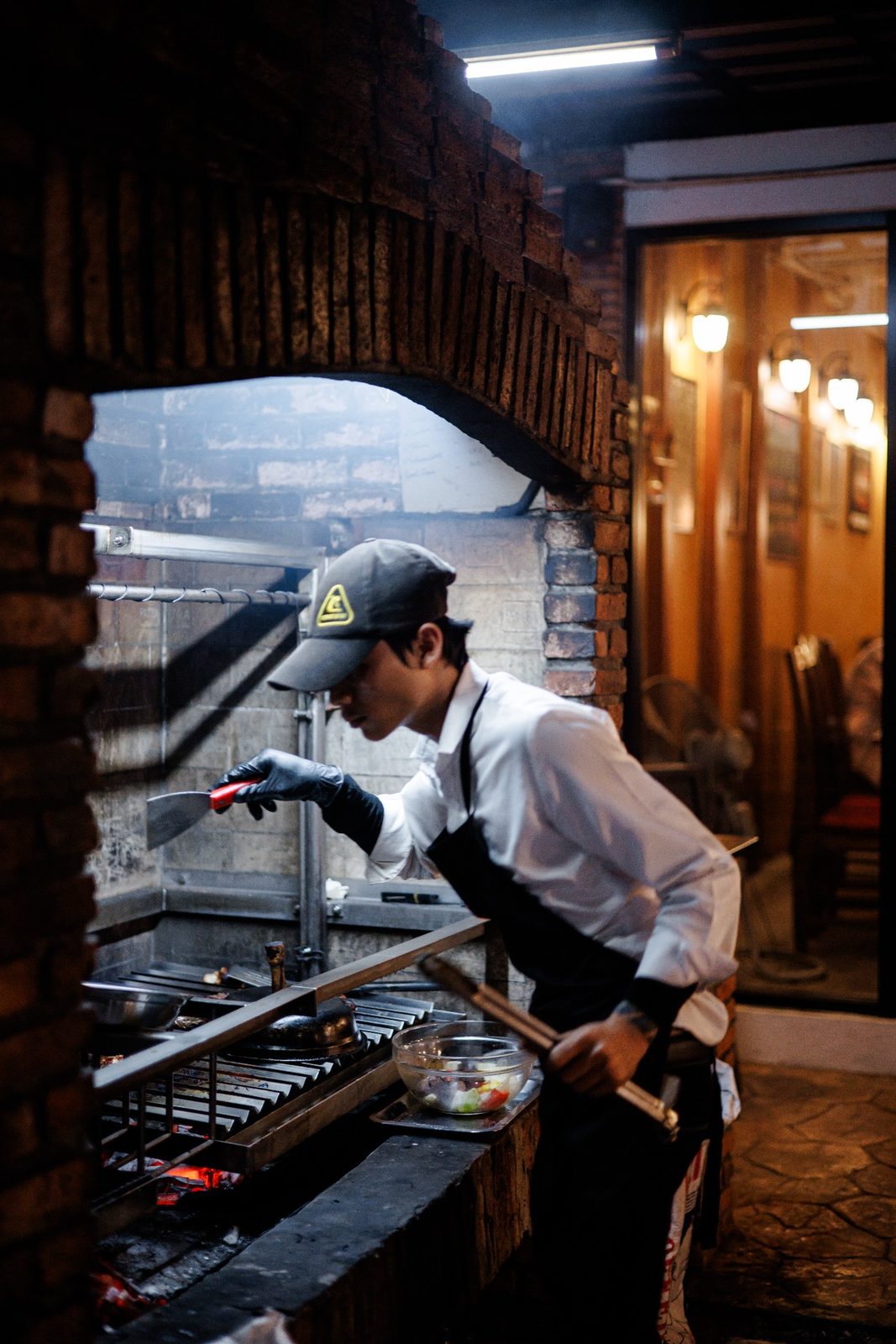Food cooking over the ASADO parrilla